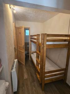 a small room with two bunk beds and a bathroom at Studio à 100 mètres du départ des pistes de ski in La Salle Les Alpes