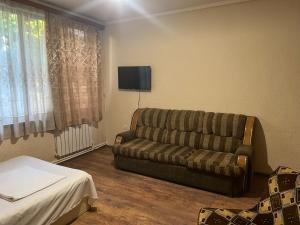 a living room with a couch and a tv at Touristic House KAEL in Musalerr