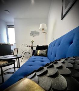 a large blue couch in a living room at 【】Le Prestigieux【】 , Belfort ville in Belfort