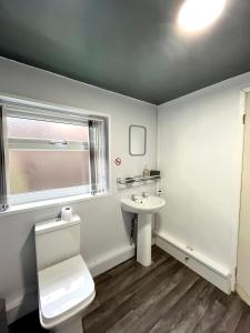 a bathroom with a white toilet and a sink at THE PORT House in Birmingham