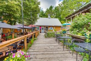 a wooden walkway with tables and chairs in front of a restaurant at Charming Stockholm Abode in Walkable Location! in Stockholm