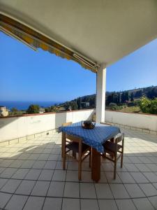 a table and chairs on a balcony with a view at BBQ HOUSE in Sanremo