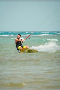 a man on a board in the water at SELENA BAY RESORT HURGHADa in Hurghada