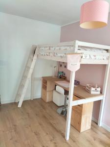 a room with a desk and a bunk bed at Maison 100m² proche sites JO2024 in Élancourt