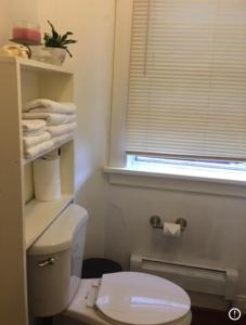 a bathroom with a white toilet and a window at Entire cozy home in U-District in Seattle