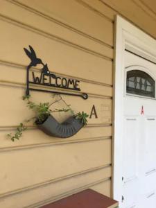 a welcome sign on the side of a house at Entire cozy home in U-District in Seattle