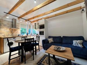 a living room with a blue couch and a table at Pod gwiazdami in Kałtki