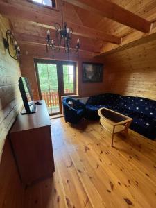 a living room with a couch and a table at Zielkowa Ostoja in Niesiołowice