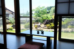 a table sitting in a room with a window at Forest-inn Kasama in Kasama