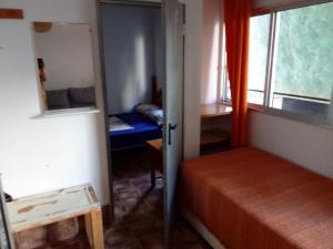 a small bedroom with a bed and a window at Apartment El Solcito in Alicante