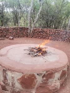 a fire pit in front of a brick wall at Impala trailor tent in Thabazimbi