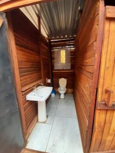 a small bathroom with a toilet and a sink at Impala trailor tent in Thabazimbi