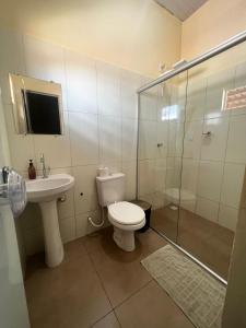 a bathroom with a toilet and a sink and a shower at HOSTEL GIRASSOL in Ponte Alta do Norte