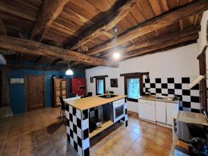 a kitchen with a checkered island in a room at Casa Rural Gaztandizabal in Aia