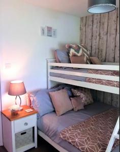 a bedroom with a bunk bed and a table with a lamp at Springer Villa, 2 bed, Newquay in Newquay