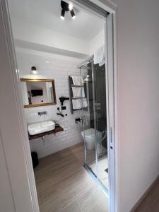 a bathroom with a glass shower and a sink at Medusa Duomo Guest House in Naples