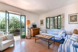 a living room with a couch and a table at Villa Le Tre Palme in Porto Azzurro