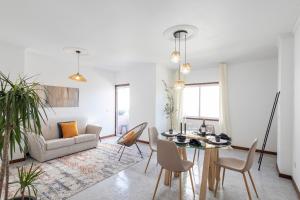 a living room with a table and a couch at Braga 3BR Wonder by LovelyStay in Braga