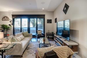 a living room with a couch and a tv at Downtown Condo City Center in Asheville