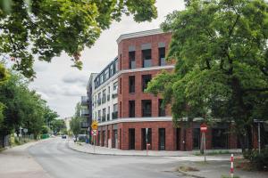 a red brick building on the side of a street at LUNA Apartment in Toruń