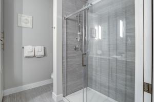 a bathroom with a shower with a glass door at Downtown Condo City Center in Asheville +10 photos