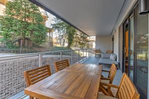 a balcony with a wooden table and chairs at Downtown Condo City Center in Asheville