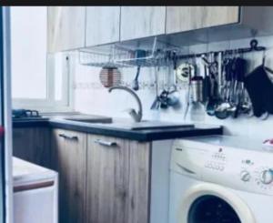 a kitchen with a sink and a washing machine at L'angolo della felicità in Marina di Montenero