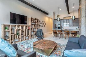 a living room with a couch and a table at Exceptional Downtown Condo in Asheville +7 photos