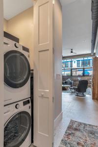 a laundry room with a washing machine and a door at Exceptional Downtown Condo in Asheville