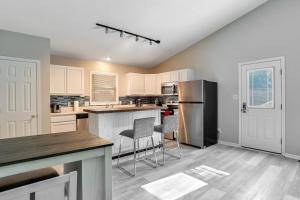 a kitchen with white cabinets and stainless steel appliances at South Asheville Townhome 12 B in Arden