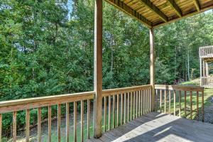 a porch of a wooden cabin with trees at South Asheville Townhome 12 B in Arden