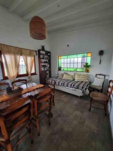 a bedroom with a bed and a table and chairs at Casa de campo in Mercedes