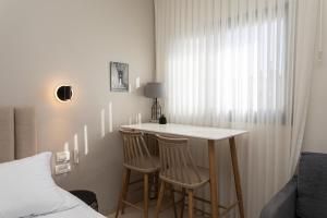 a room with a table and two chairs and a bed at Carmel Studio By Carmel Boutique in Haifa