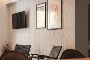 a waiting room with chairs and pictures on the wall at Vallia Suites-Red Luxury Suite B3 in Nafpaktos