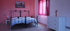 a bedroom with a bed and a dresser and a window at Villa Lancellotti in Agropoli +18 photos