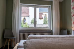 a bedroom with two beds and a large window at Ferienwohnung Nadine Petschler in Obereisenheim