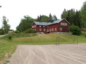 a large red barn with a goal in front of it at Folsom in Årjäng