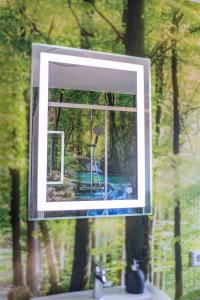 a mirror on a window over a sink at Ferienwohnung Nadine Petschler in Obereisenheim