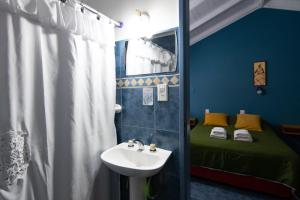 a bathroom with a sink and a bed at Hosteria Patagonia in El Calafate