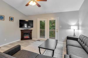 a living room with a couch and a fireplace at South Asheville Townhome 14 A in Arden