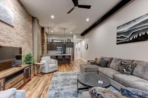 a living room with a couch and a table at Fabulous Downtown 2 bedroom Condo in Asheville +4 photos