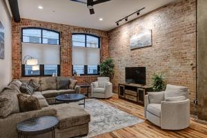 a living room with a brick wall at Fabulous Downtown 2 bedroom Condo in Asheville