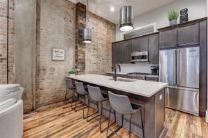 a kitchen with a large island with bar stools at Fabulous Downtown 2 bedroom Condo in Asheville