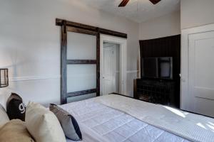 a bedroom with a large bed and a television at 235 East Chestnut in Asheville