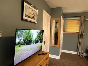 a flat screen tv sitting on top of a wooden table at SELF Check In Room Accommodation ONLY The Castle, Coldstream in Coldstream