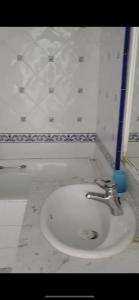 a bathroom with a white sink in a room at Grand appartement vue sur port à Marina smir in M'diq