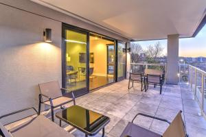 a balcony with chairs and tables on a building at 145 Biltmore Ave Condo 541B0A in Asheville