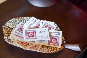 a plate with a pile of cards on a table at Къща ЕТНО in Koprivshtitsa