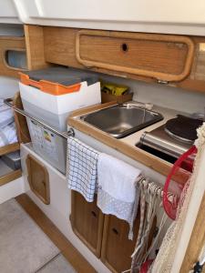 a kitchen with a sink and a stove at Veleiro Senhora Brava in Olhão