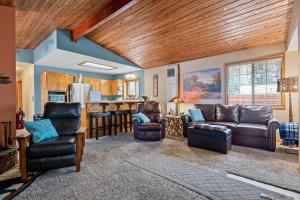 a living room with a couch and a kitchen at Coy Cottage - NEAR OKTOBERFEST! Calm & quite location within minuets of the heart of town! in Big Bear City